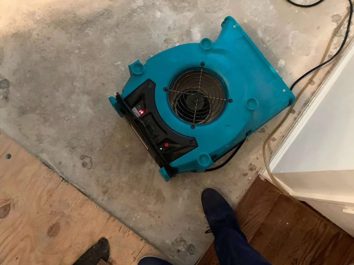 Air mover drying subfloor during Commercial Water Damage Restoration in Hilliard